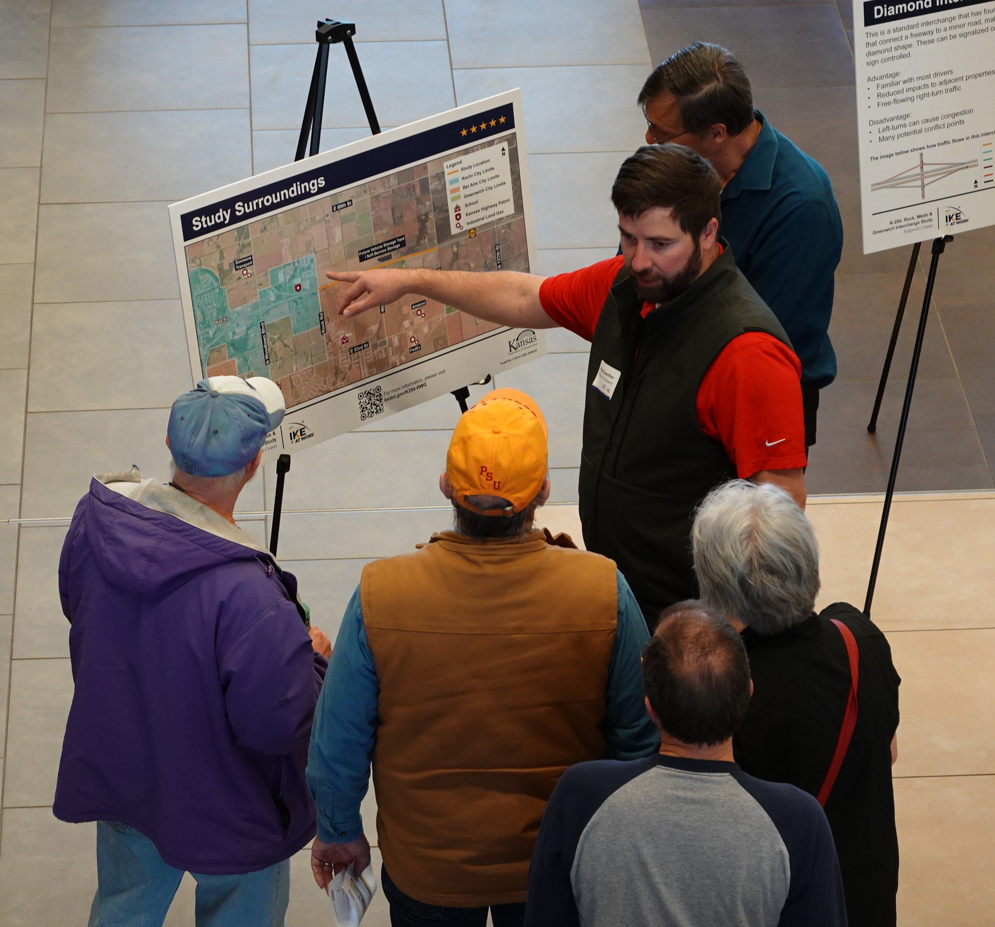 K 254 project team member stands at project display board at public open house. 